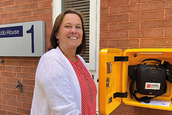 Councillor Alicia Marland with the defibrillator at Lido House in Grotton