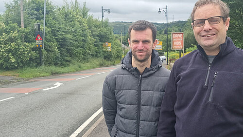 Councillors Michael Powell and Garth Harkness at the side of the road in Denshaw where they have requested speed cameras